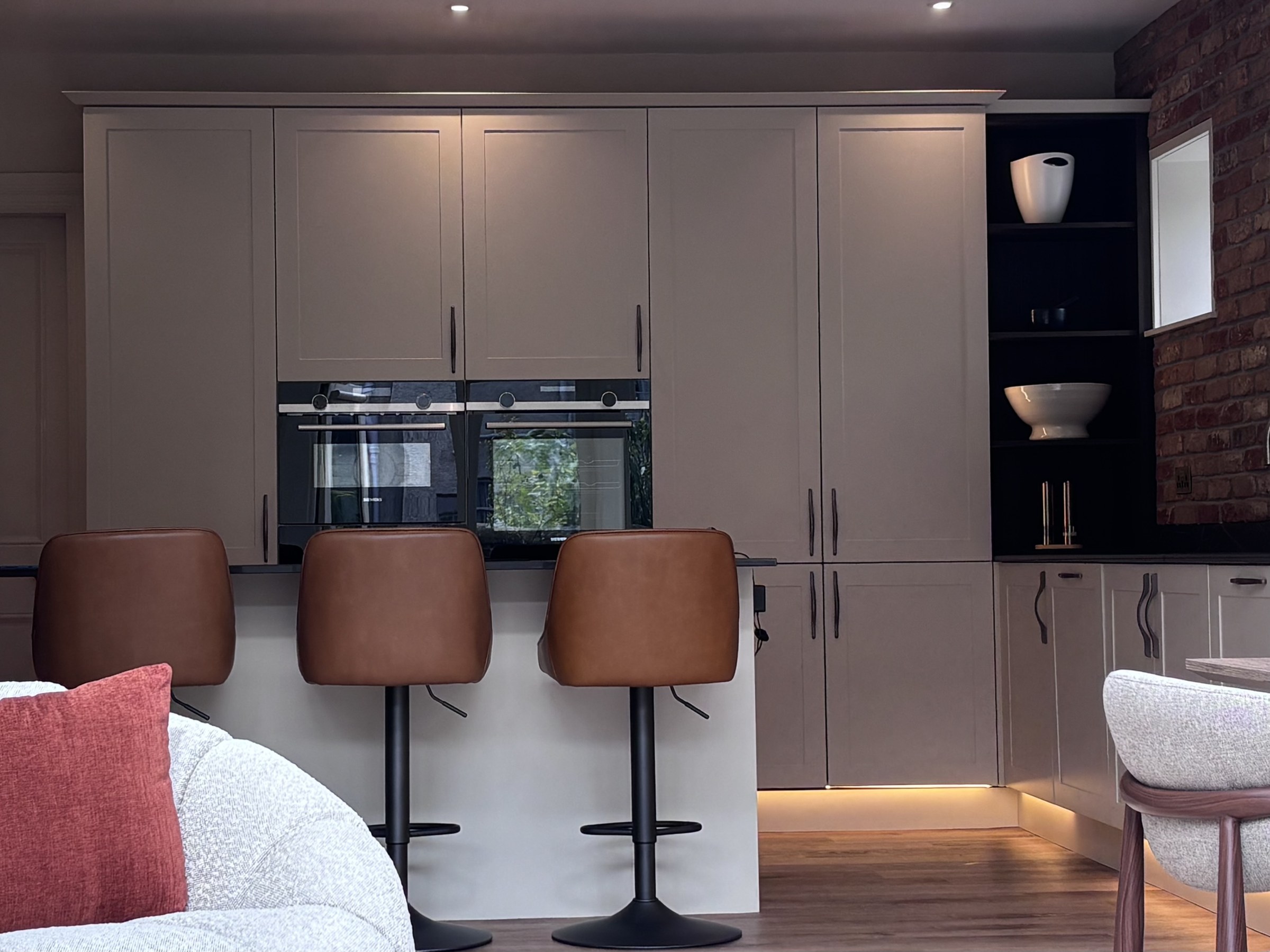 Kitchen cabinetry, integrated appliances and breakfast bar seating