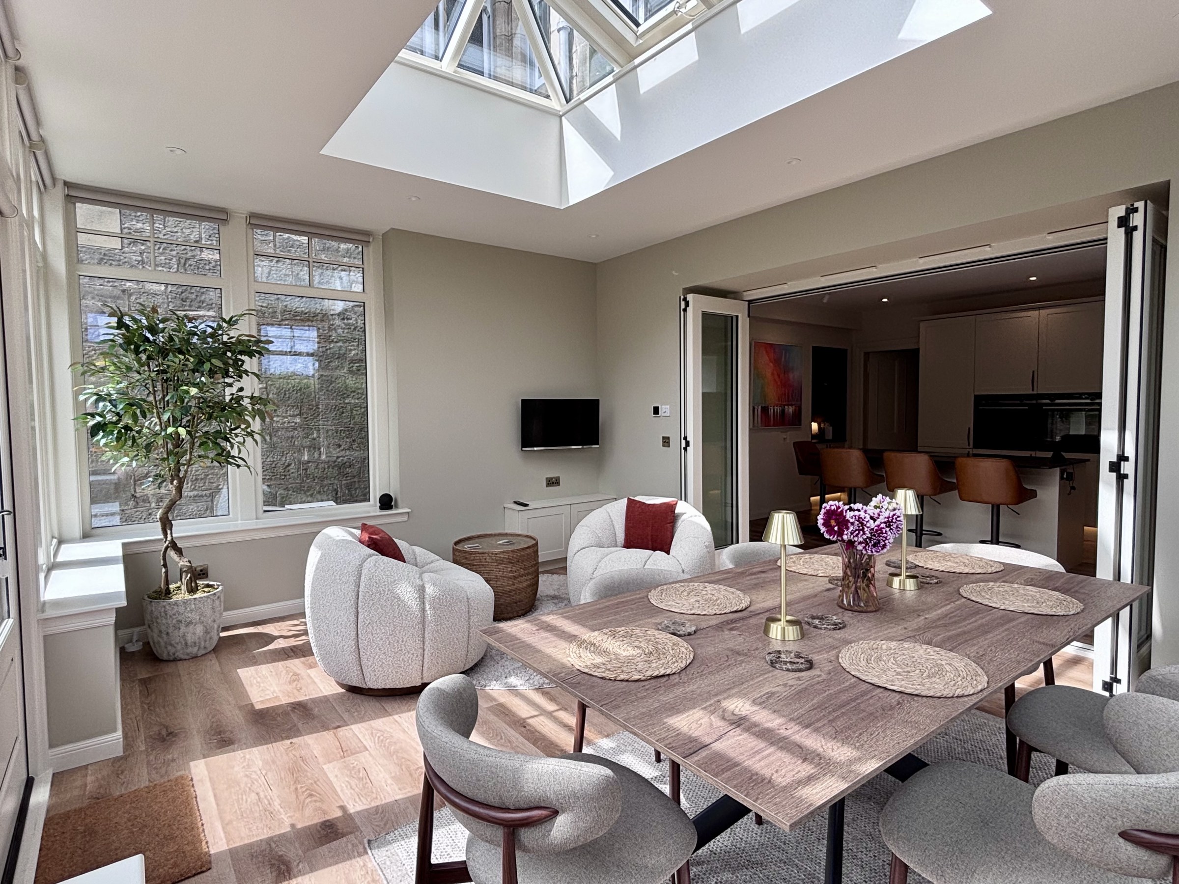 Dining table beneath the conservatory roof beside the kitchen