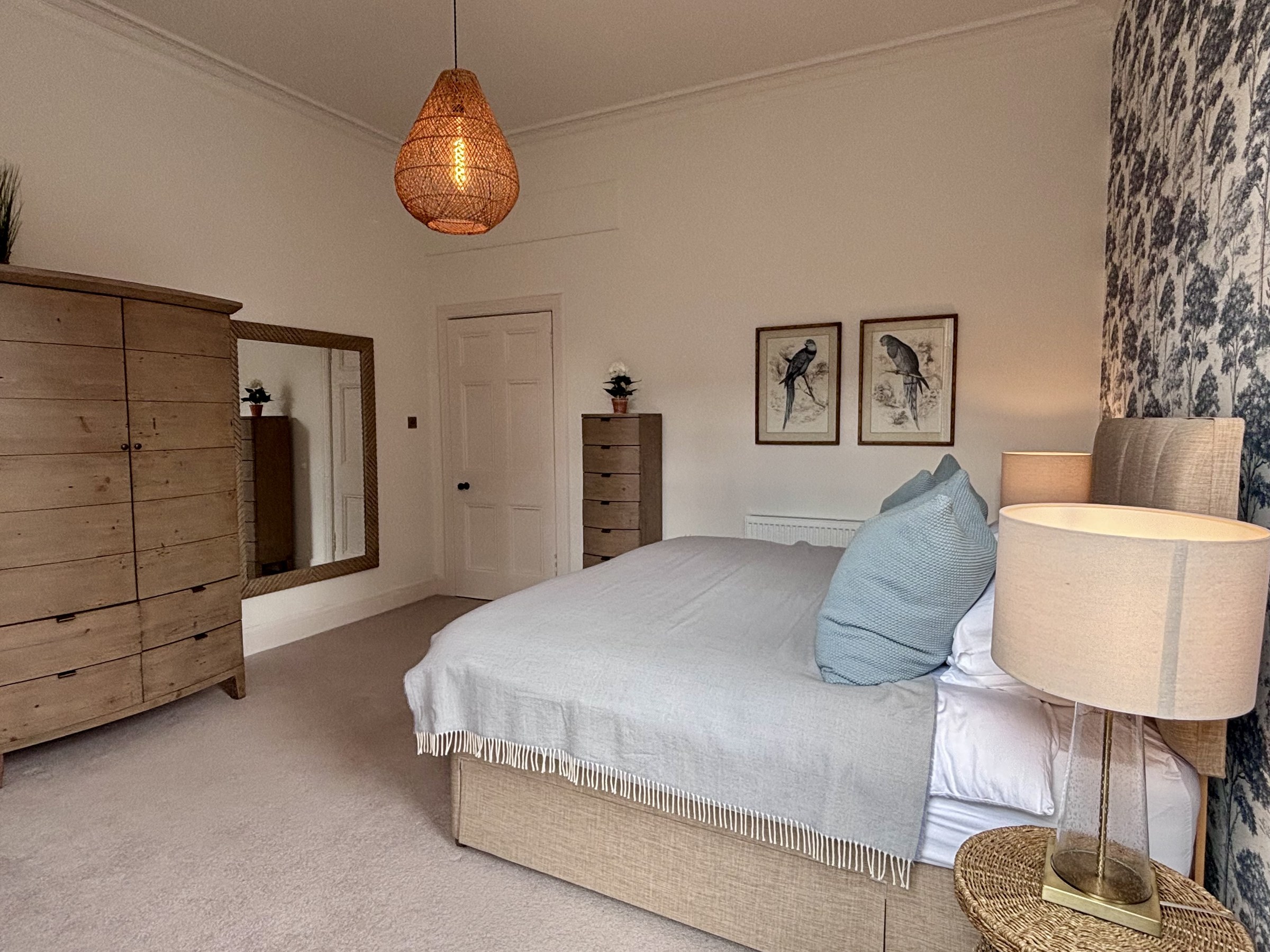 Bedroom with a double bed, timber wardrobe and pendant light