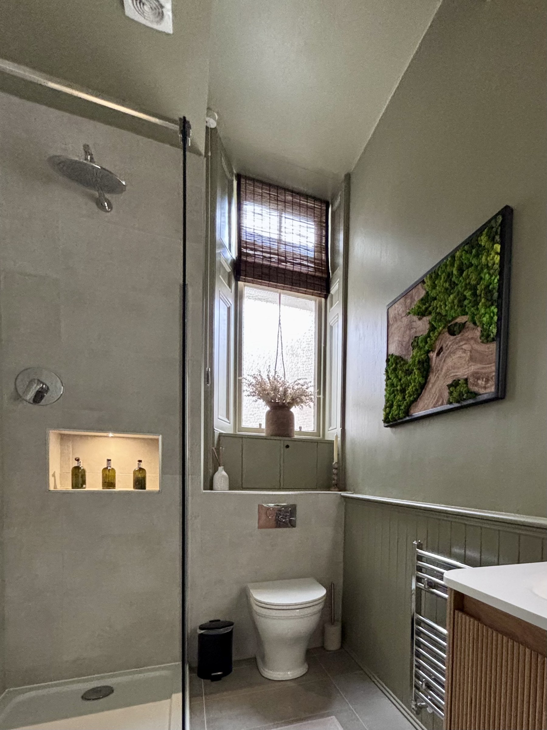 Bathroom with a walk-in shower, basin and window