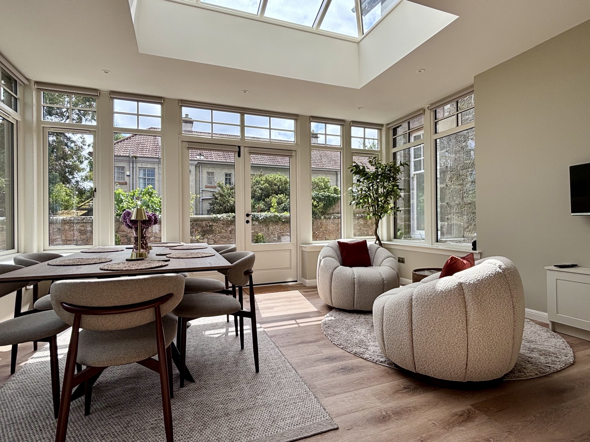 Conservatory dining and seating overlooking the garden